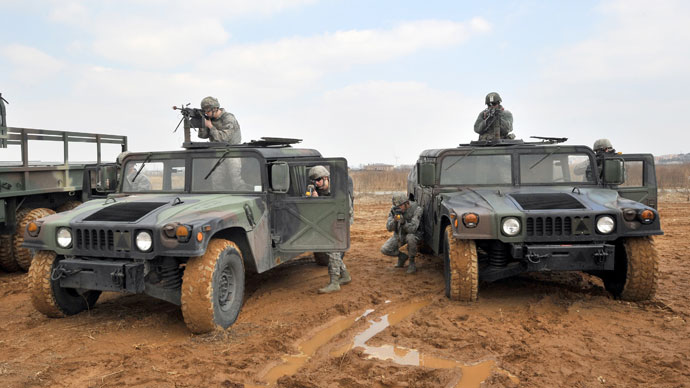 US Air Force soldiers aim their weapons from behind their vehicles during a drill as part of annual joint exercises with South Korea outside a US airbase in Pyeongtaek, south of Seoul, on March 14, 2013.(AFP Photo / Jung Yeon-Je)