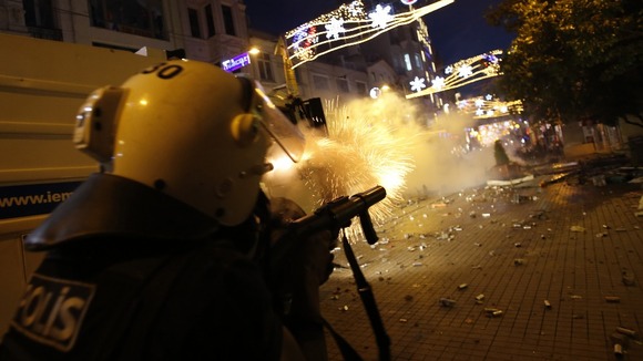 REUTERS/Murad Sezer A cop in Istanbul fires at protesters.