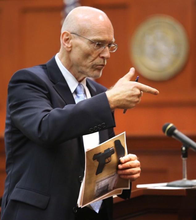 Don West, a defense attorney for George Zimmerman makes a gun gesture, describing the shooting of 17-year-old Trayvon Martin to the jury.