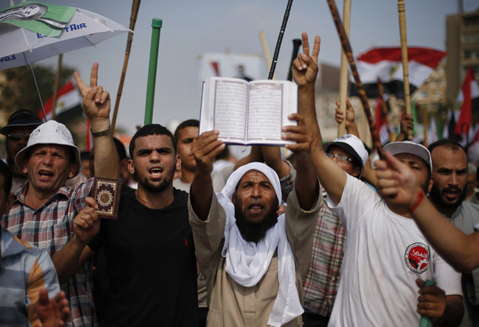 Supporters of Egyptian President Mohamed Morsi hold copies of the Koran during a protest around the Raba El-Adwyia mosque square in Nasr City, in the suburb of Cairo June 30, 2013. (Reuters)