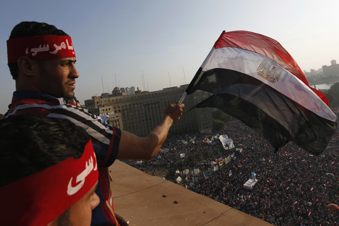 Protesters wave Egyptian flags as demonstrators opposing Egyptian President Mohamed Morsi shout slogans against him and Brotherhood members during a protest at Tahrir Square in Cairo June 30, 2013. (Reuters/Mohamed Abd El Ghany)