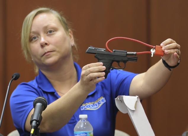 Diana Smith, crime scene technician for the Sanford Police Department, shows the jury George Zimmerman's gun. The 9mm Kel-Tec pistol will be returned to him now that he was found not guilty.