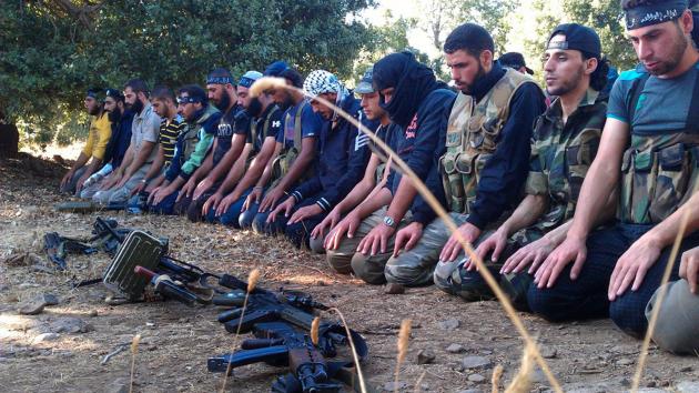 Members of the Free Syrian Army perform prayers in Damascus in August 13, 2012. UPI 