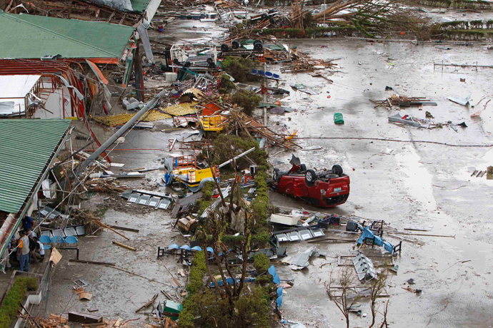 A damaged car is seen in front of the airport after super Typhoon Haiyan battered Tacloban city, central Philippines, November 9, 2013 (Reuters / Romeo Ranoco)
