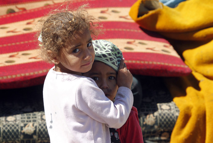 Palestinian refugee children from Syria stands outside tents at Ain al-Helweh Palestinian refugee camp near the port-city of Sidon, southern Lebanon (Reuters/Ali Hashisho)